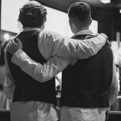 Two members standing arm in arm