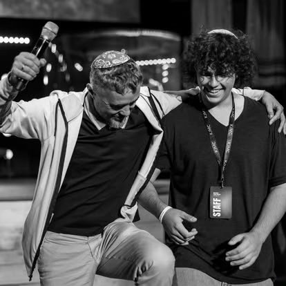 Two members embracing joyfully at a gathering